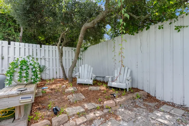 a view of a house with backyard sitting area and garden