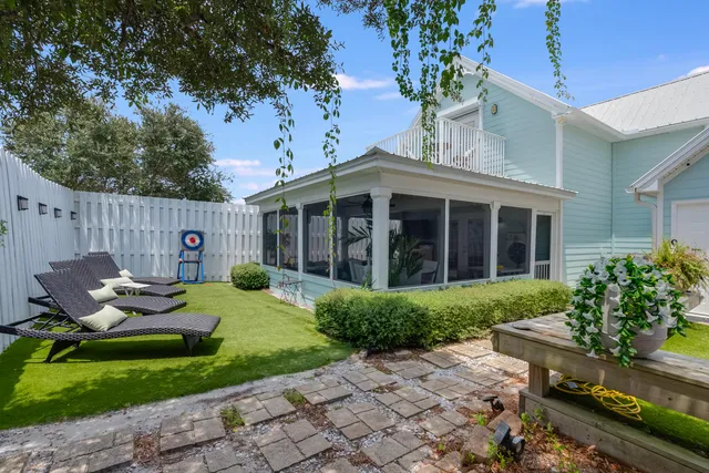 a backyard of a house with table and chairs