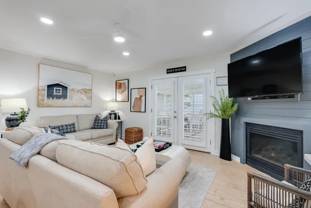 a living room with furniture a flat screen tv and a fireplace