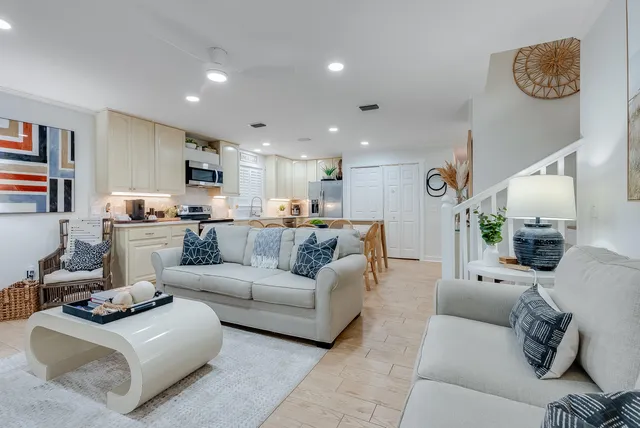 a living room with furniture and kitchen view