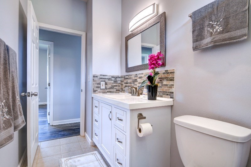 11-3723 Old Volcano Road Volcano, HI 96785 - Photo 8 of 18 a bathroom with a sink vanity mirror and toilet