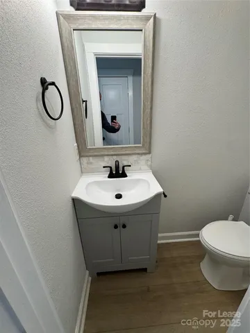 a view of a room with wooden floor