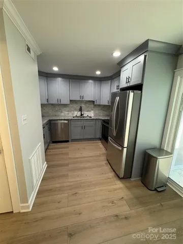 a kitchen with stainless steel appliances granite countertop a refrigerator sink and cabinets