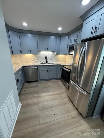 a stove top oven sitting inside of a kitchen
