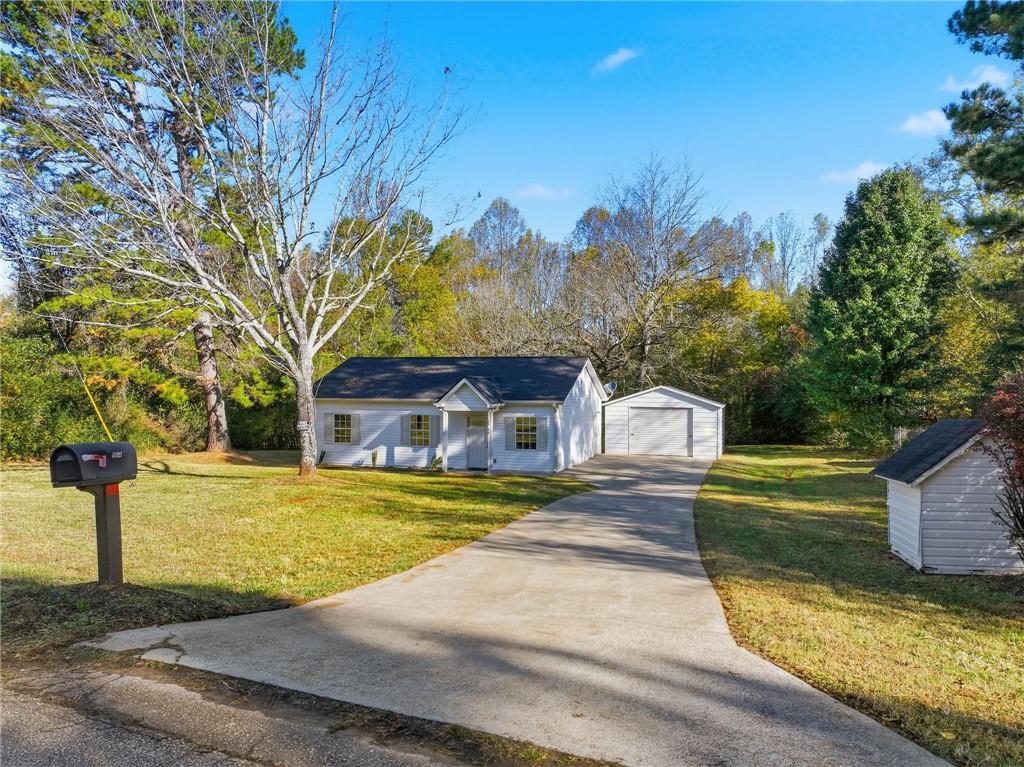 a front view of a house with a yard garage and outdoor seating