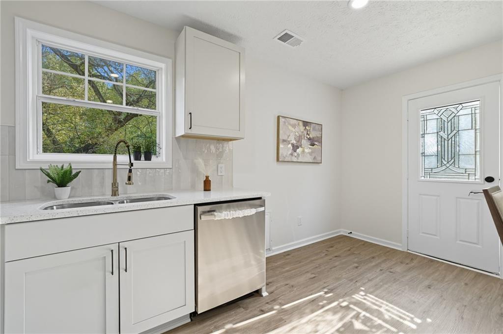 6964 Wheeler Road Lula, GA 30554 - Photo 13 of 27 a kitchen with a sink and cabinets