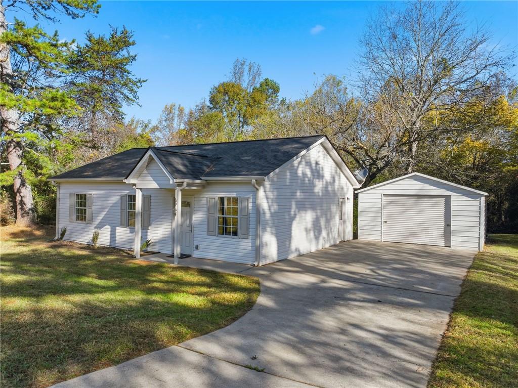 6964 Wheeler Road Lula, GA 30554 - Photo 2 of 27 a front view of a house with a yard and garage