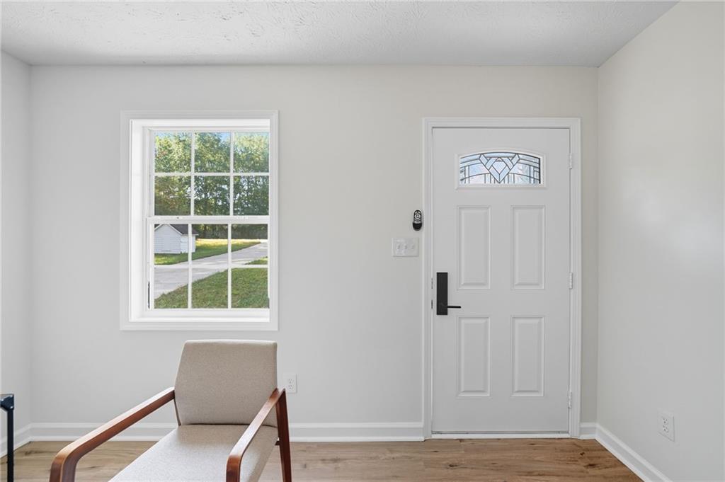 6964 Wheeler Road Lula, GA 30554 - Photo 5 of 27 a view of a room that has a window and wooden floor