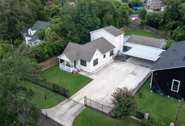 an aerial view of a house with a yard