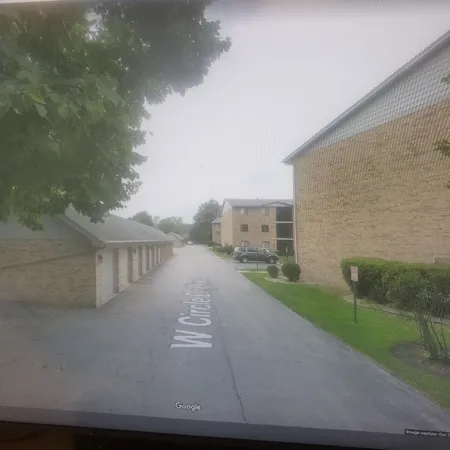 a view of a street with brick building in front of it