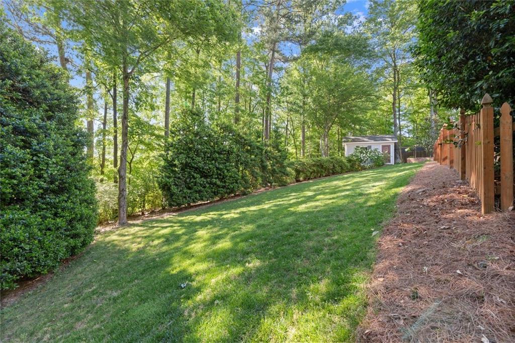 1450 Acworth Due West Road Northwest Kennesaw, GA 30152 - Photo 65 of 77 a view of a yard with large trees