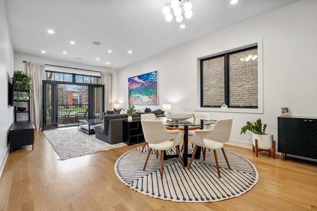 a dining room with wooden floor a glass table and chairs