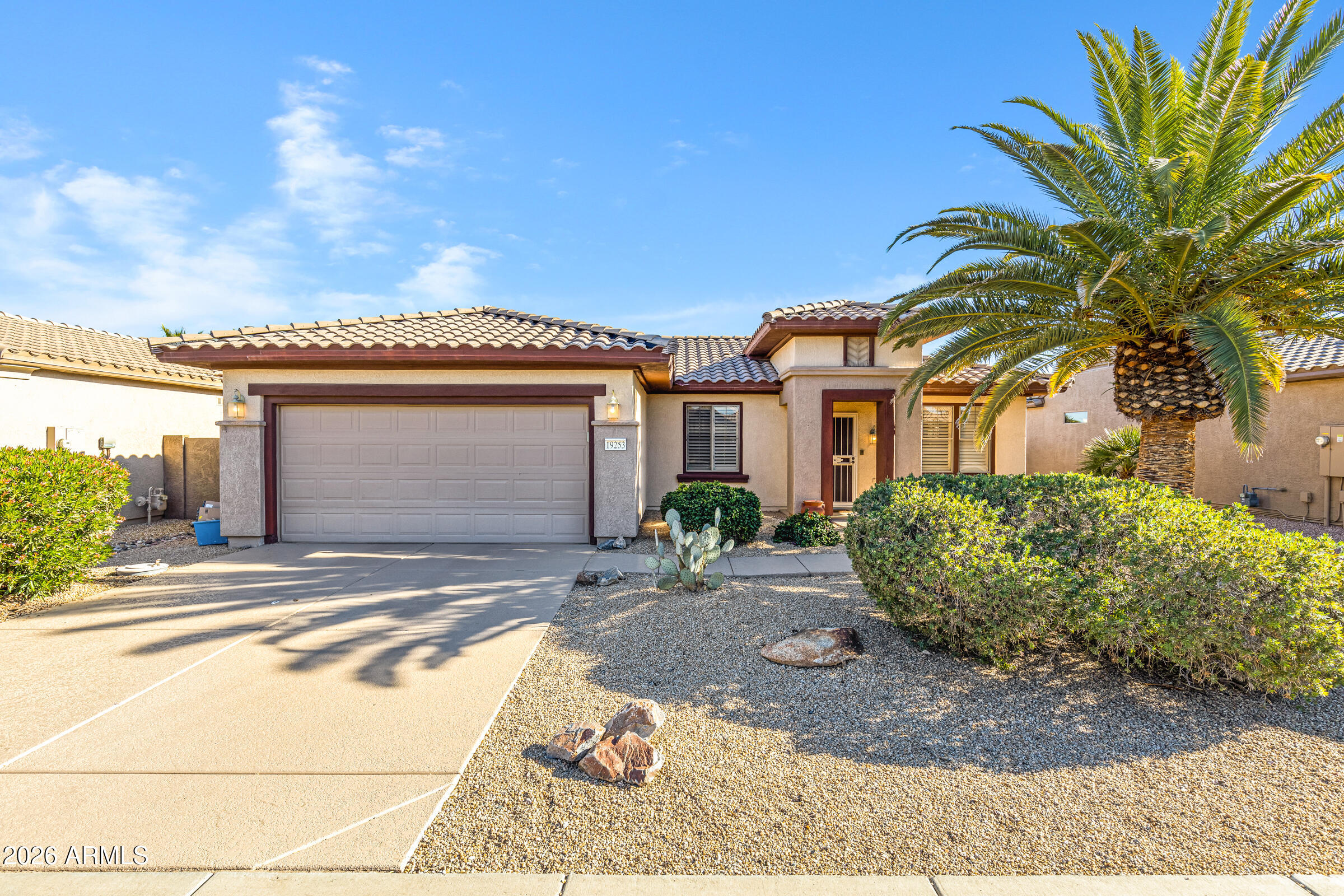 19253 North Hunters Run Surprise, AZ 85387 - Photo 1 of 30 a front view of a house with a garden