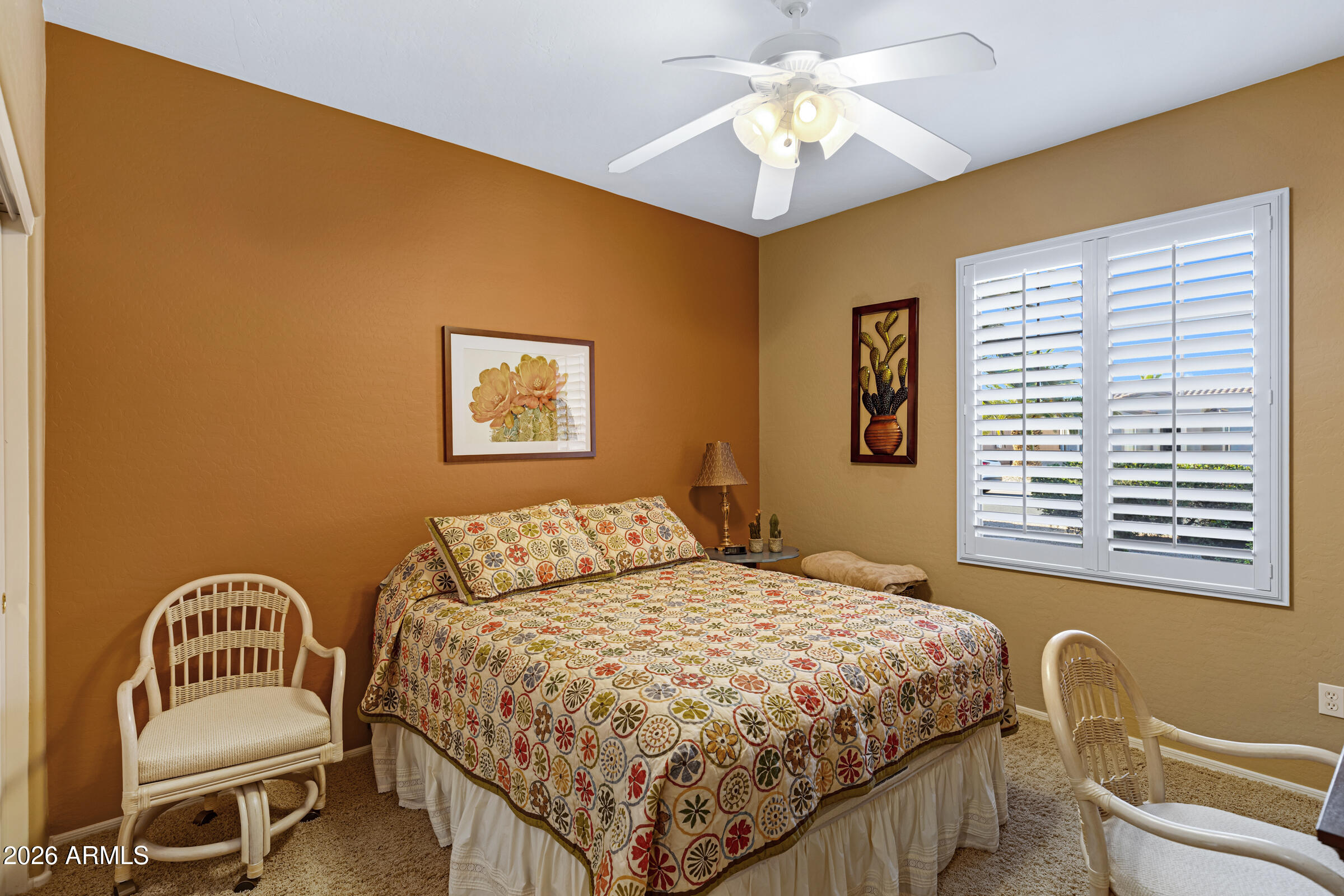 19253 North Hunters Run Surprise, AZ 85387 - Photo 16 of 30 a bedroom with a bed and a chandelier