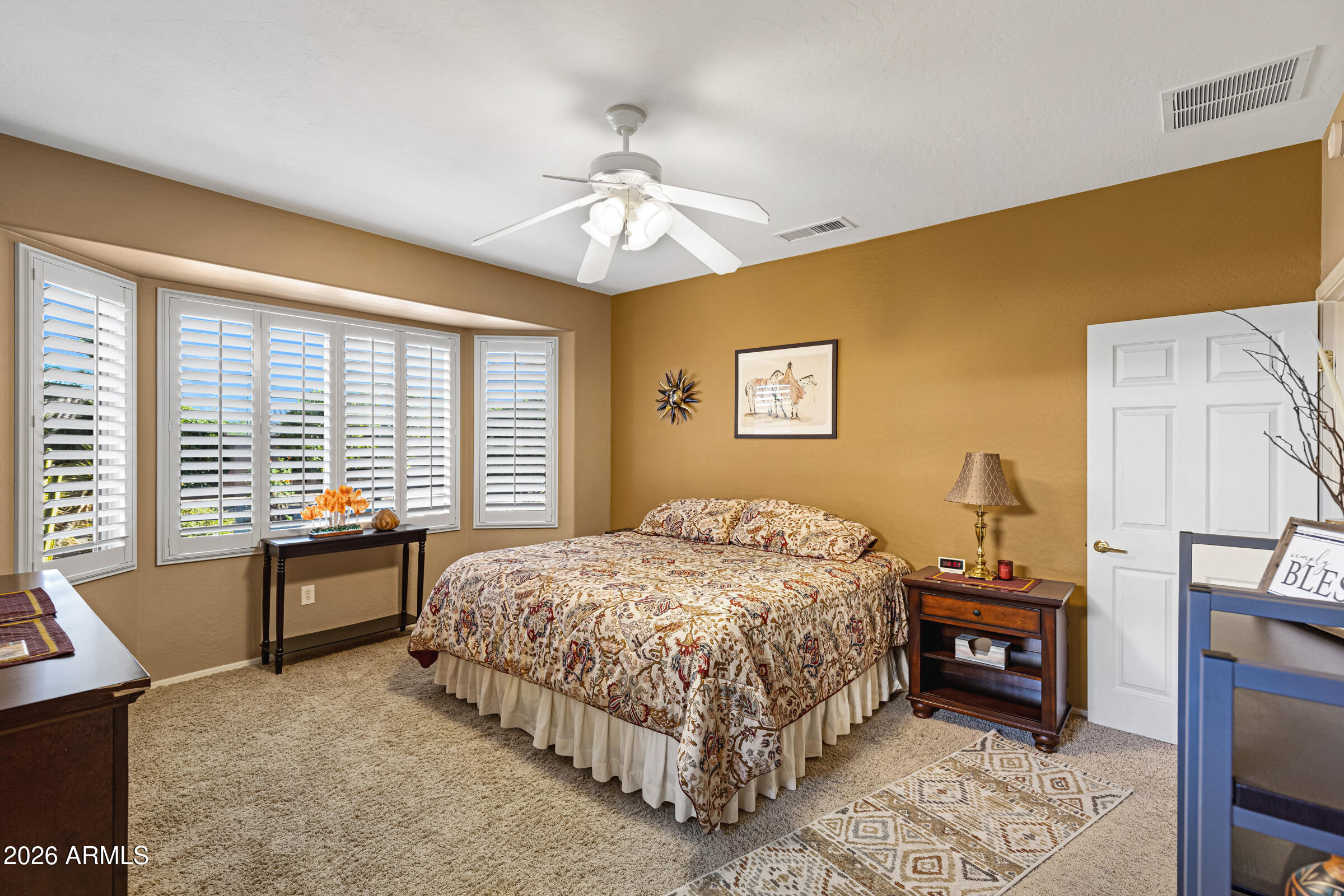 19253 North Hunters Run Surprise, AZ 85387 - Photo 19 of 30 a bedroom with a bed and a chandelier