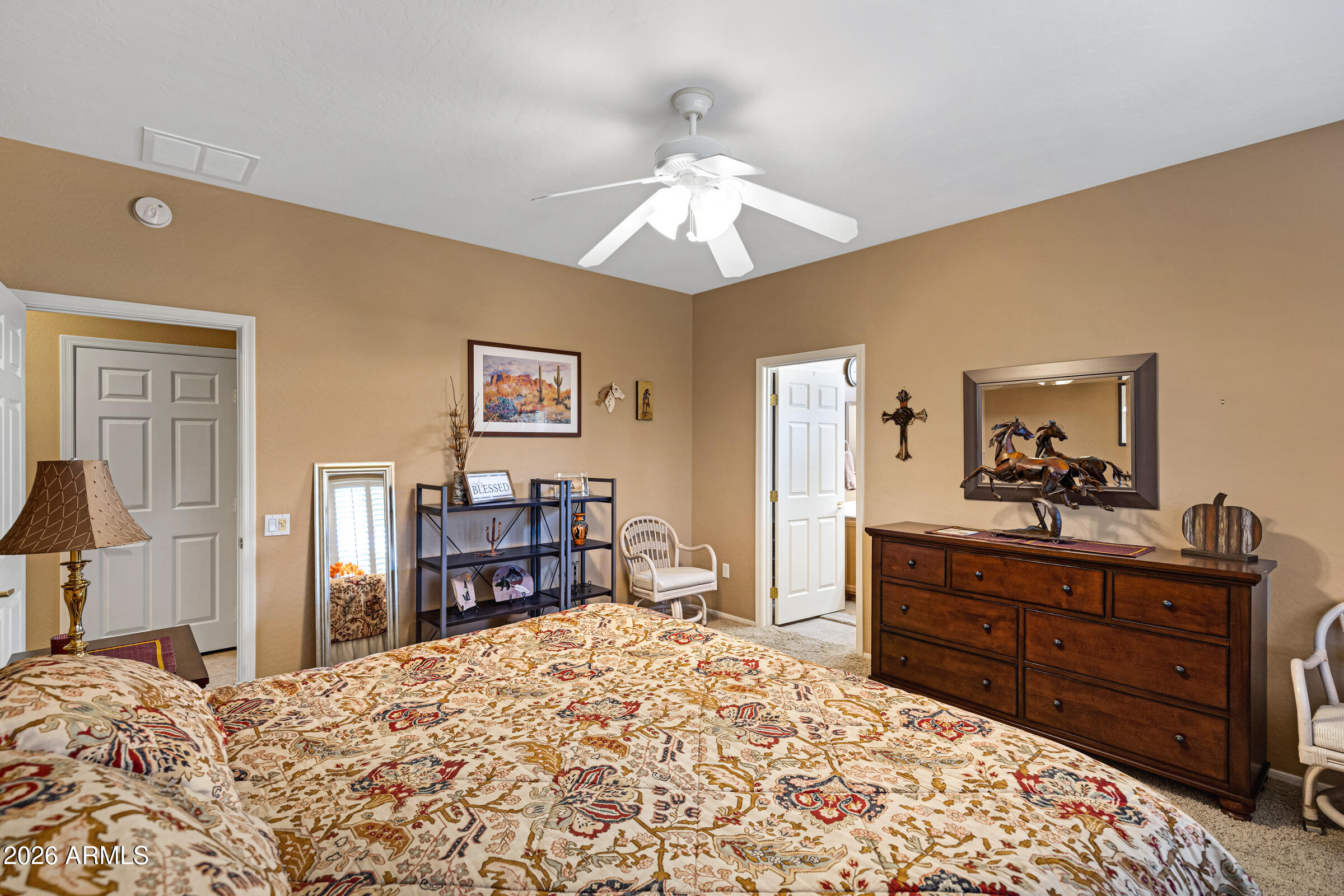 19253 North Hunters Run Surprise, AZ 85387 - Photo 20 of 30 a bed room with a bed and a dresser in it