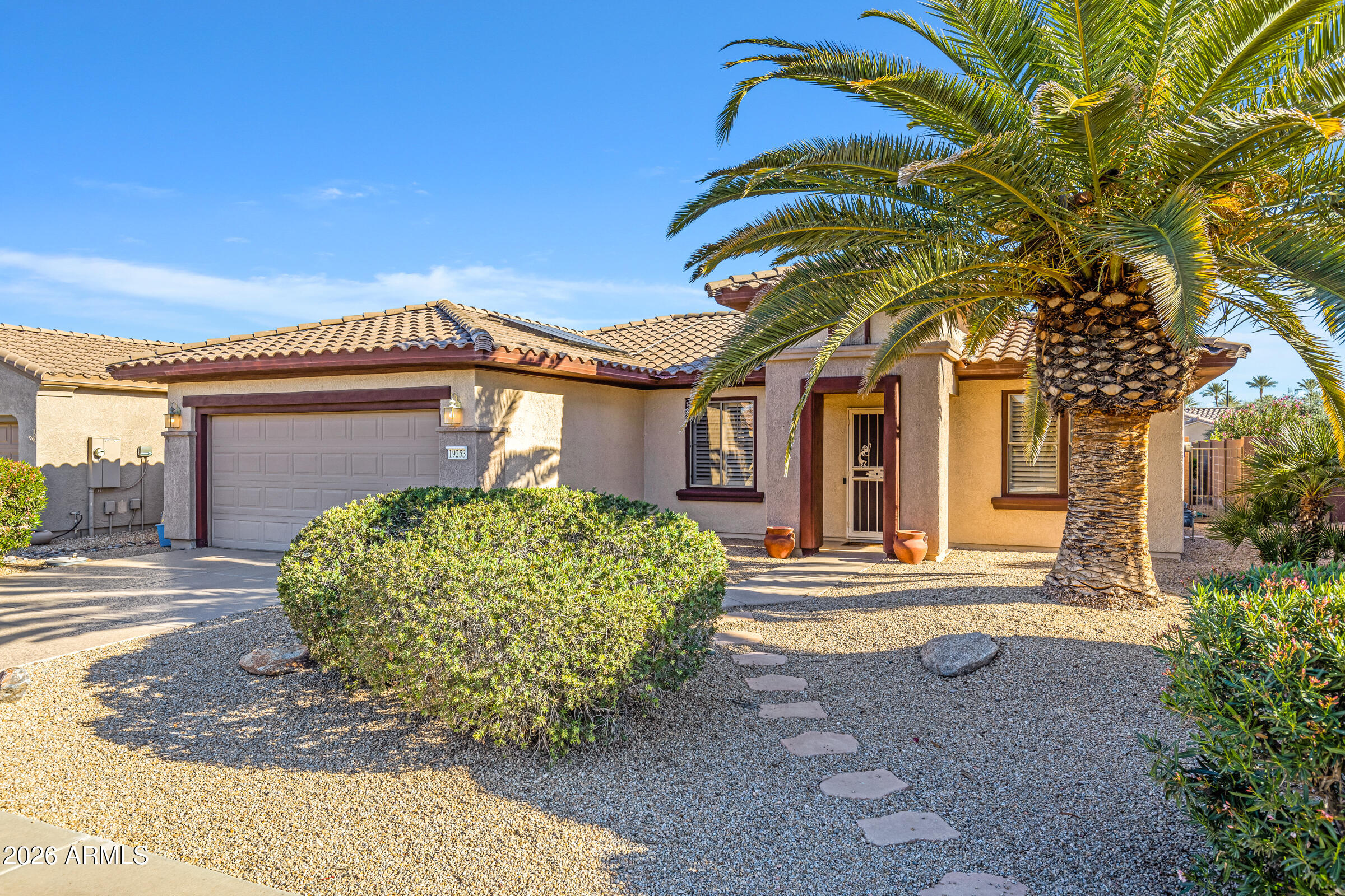 19253 North Hunters Run Surprise, AZ 85387 - Photo 2 of 30 a front view of a house with garden