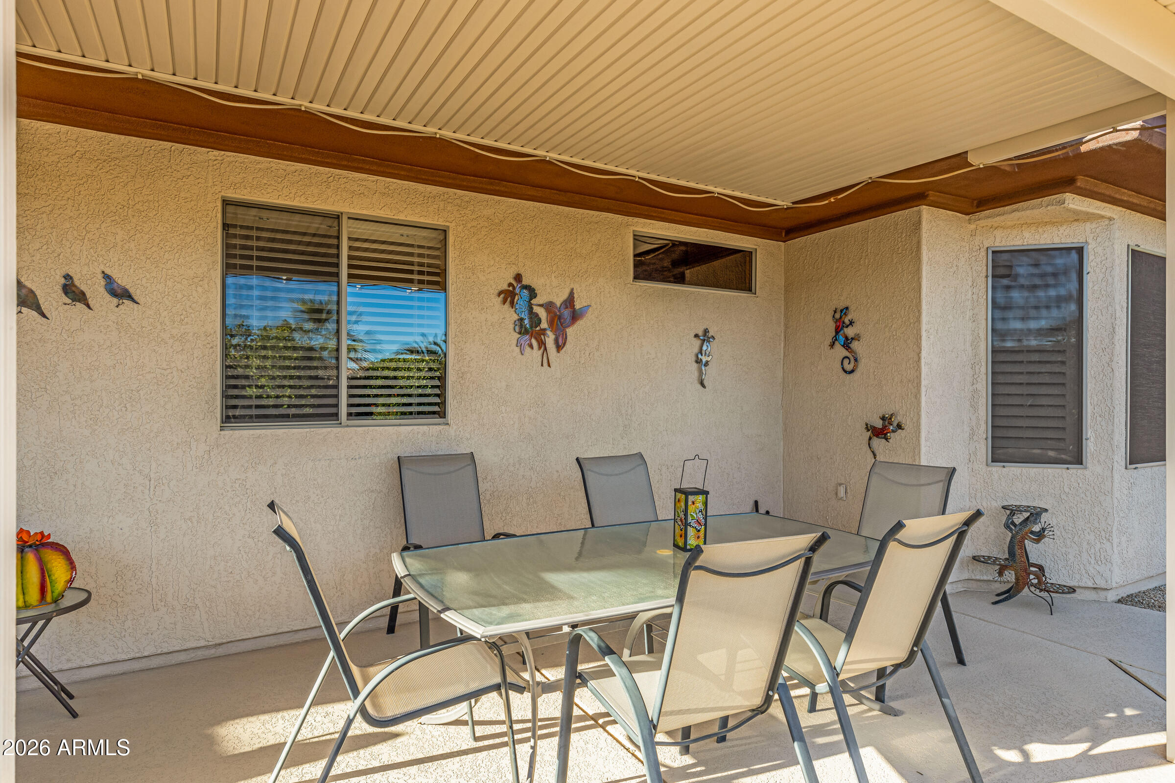 19253 North Hunters Run Surprise, AZ 85387 - Photo 30 of 30 a view of a patio with table and chairs with potted plants