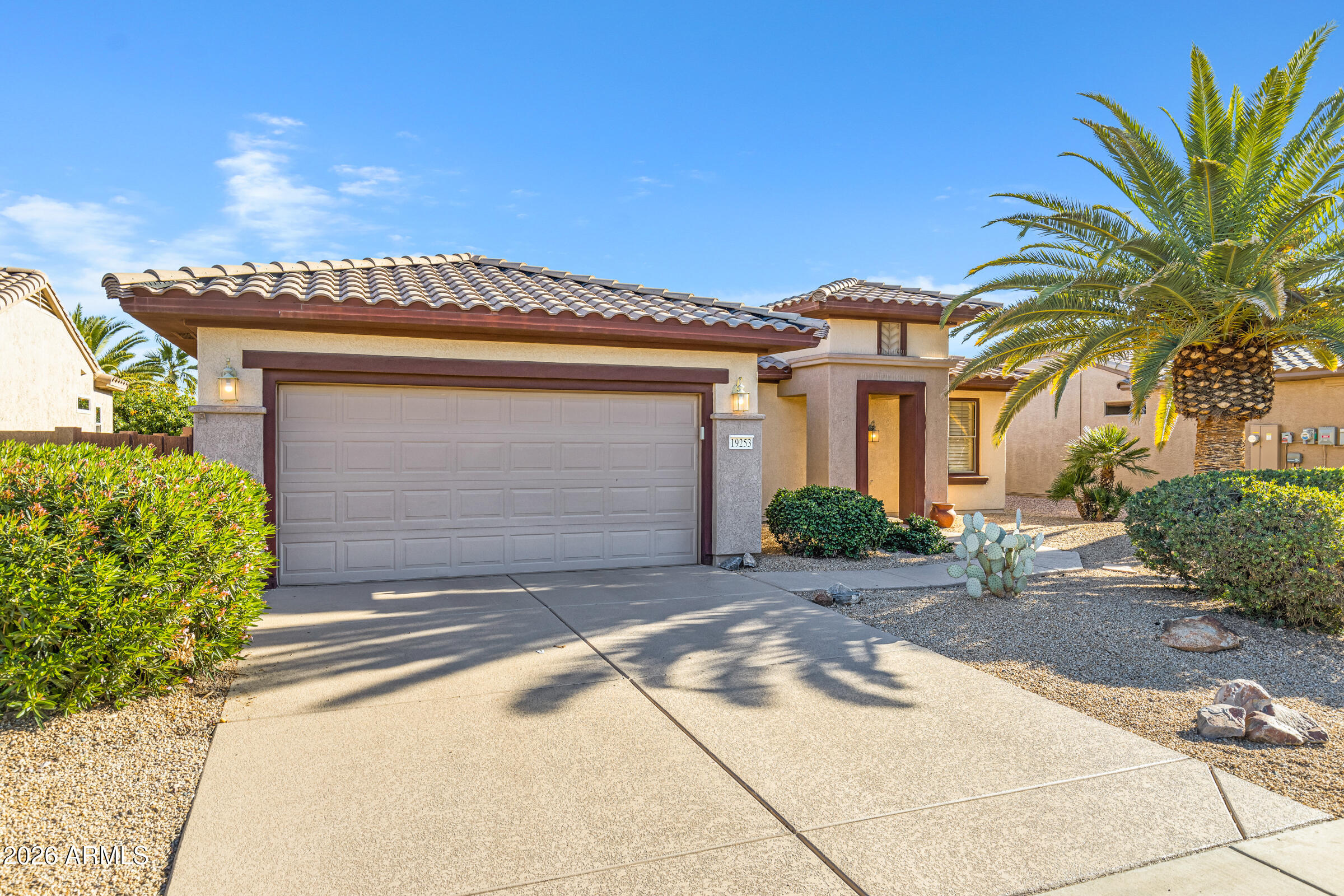 19253 North Hunters Run Surprise, AZ 85387 - Photo 3 of 30 a front view of a house with a yard