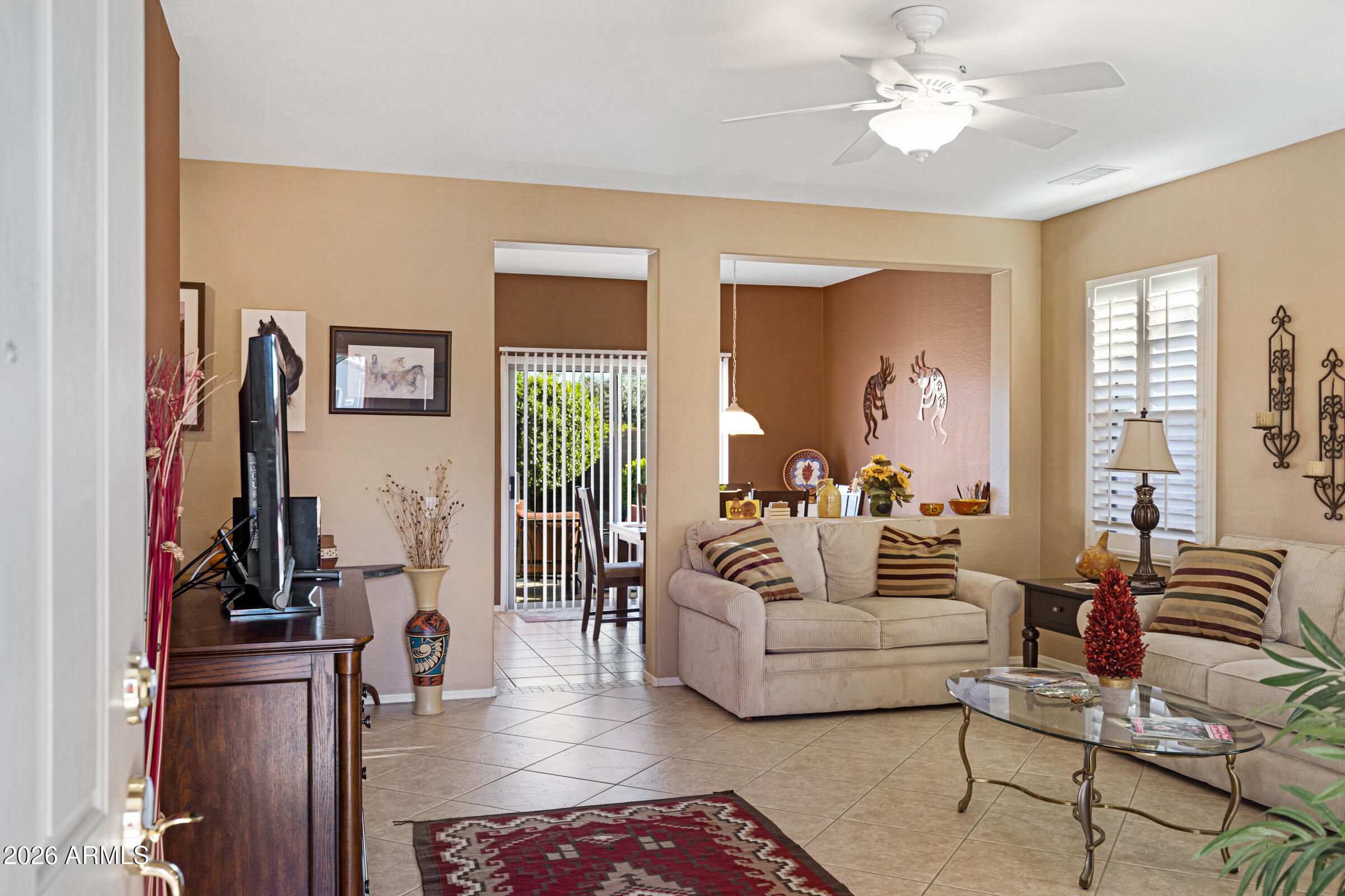 19253 North Hunters Run Surprise, AZ 85387 - Photo 5 of 30 a living room with furniture a rug and a chandelier