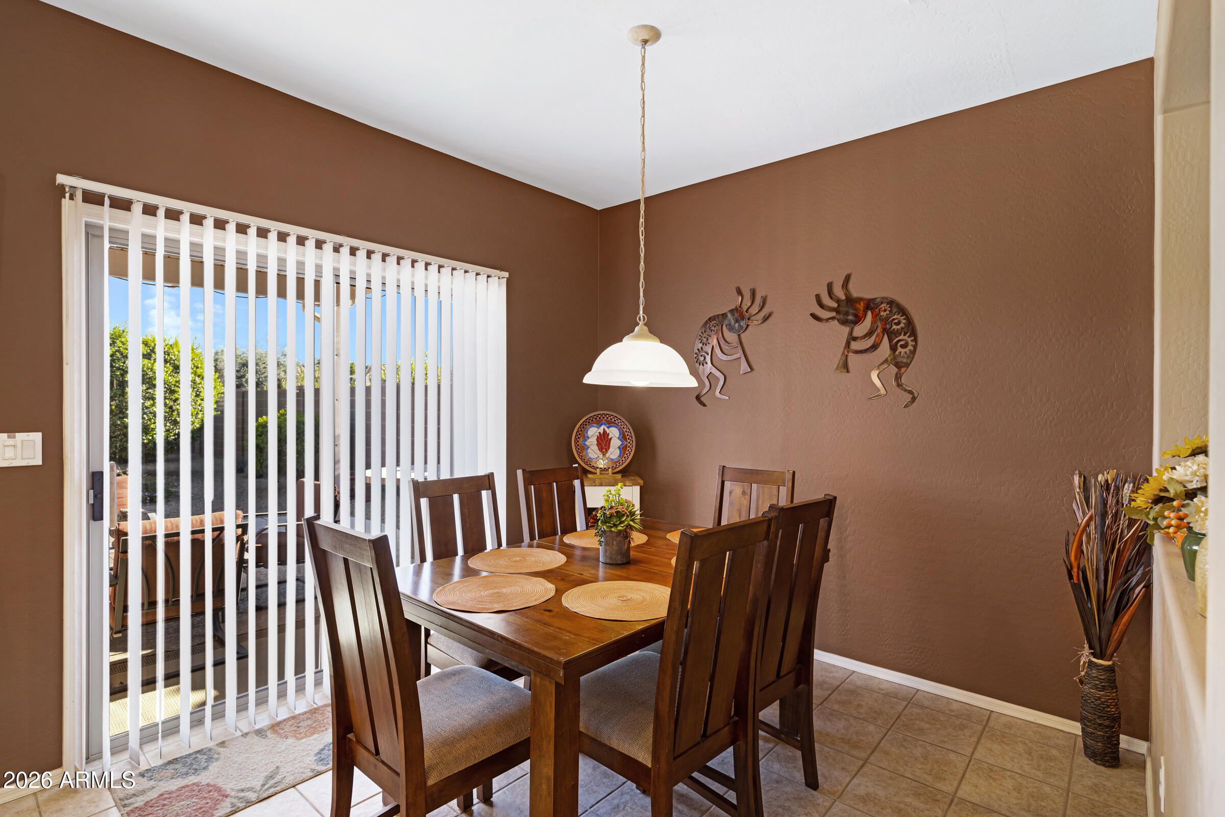 19253 North Hunters Run Surprise, AZ 85387 - Photo 9 of 30 a view of a dining room with furniture and wooden floor