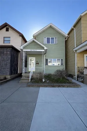 a front view of a house with yard