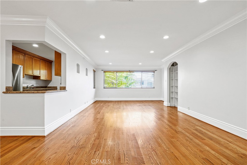 14934 Dickens Street, Unit 15 Sherman Oaks, CA 91403 - Photo 2 of 15 a view of an empty room with wooden floor and a window