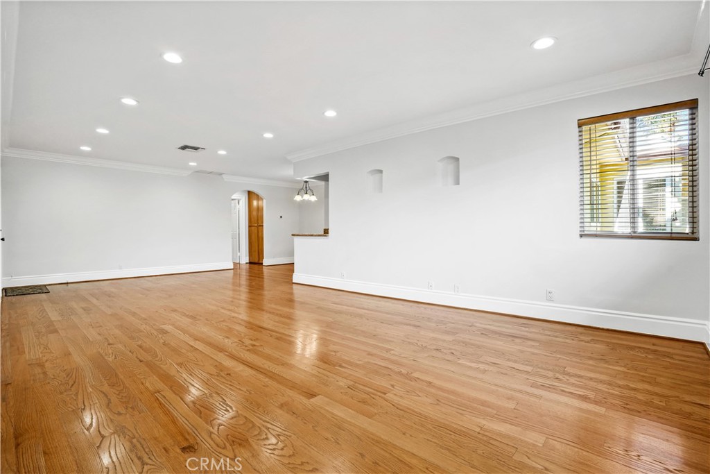 14934 Dickens Street, Unit 15 Sherman Oaks, CA 91403 - Photo 4 of 15 a view of an empty room with wooden floor and a window