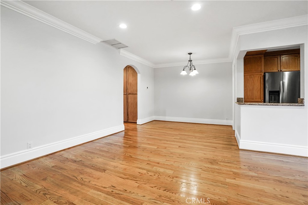 14934 Dickens Street, Unit 15 Sherman Oaks, CA 91403 - Photo 5 of 15 wooden floor in an empty room with a window
