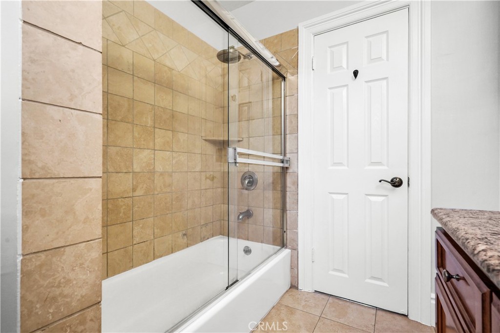 14934 Dickens Street, Unit 15 Sherman Oaks, CA 91403 - Photo 10 of 15 a bathroom with a tub a sink and a shower