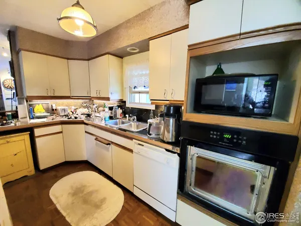 a kitchen with stainless steel appliances a stove a sink and a microwave
