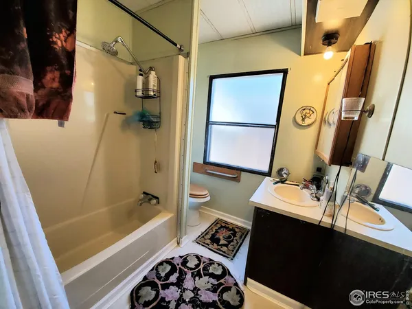 a bathroom with a sink a mirror a bathtub and a shower