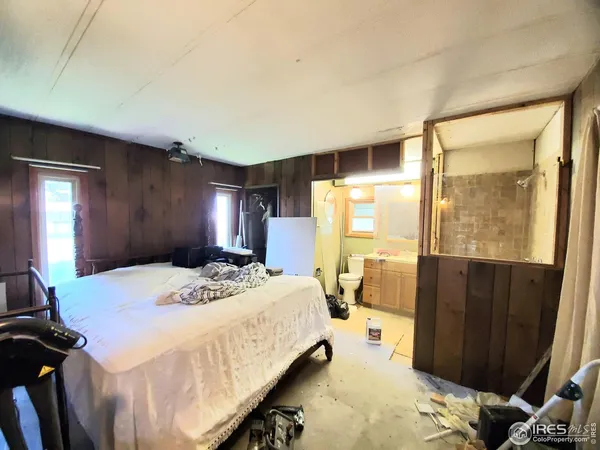 a spacious bedroom with a bed and a dresser