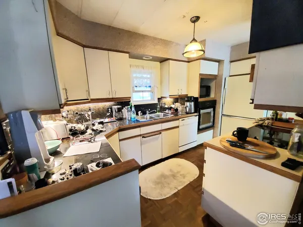 a kitchen with sink stove and chairs