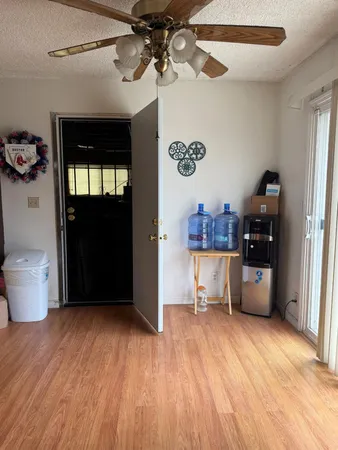 a kitchen with a sink cabinets and wooden floor