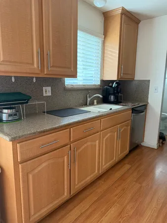 a kitchen with a refrigerator sink and stove