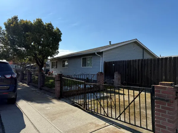 a view of house with wooden deck and furniture