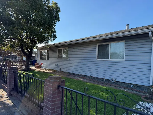 a view of a house with wooden fence