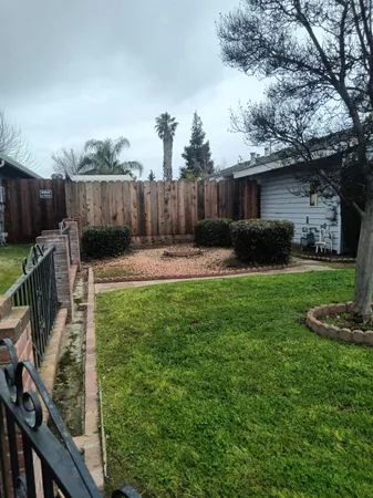a view of a backyard with furniture and a fire pit