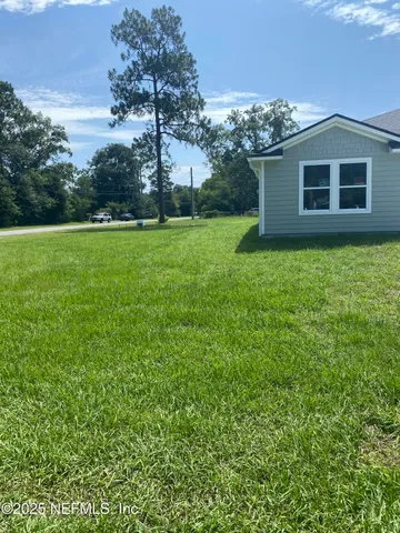 a house with green field in front of it