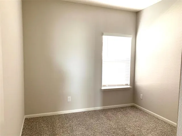an empty room with closet area