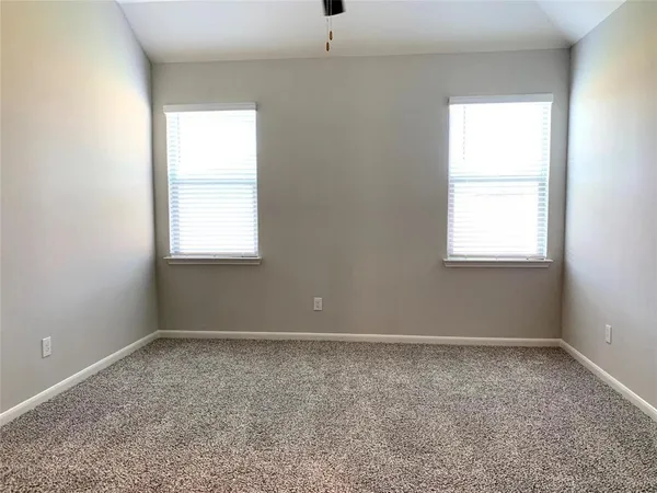 a bathroom with a granite countertop window and a shower