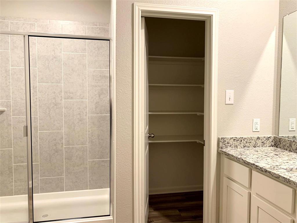 144 Emma Drive Anna, TX 75409 - Photo 22 of 34 a bathroom with a granite countertop window and a shower