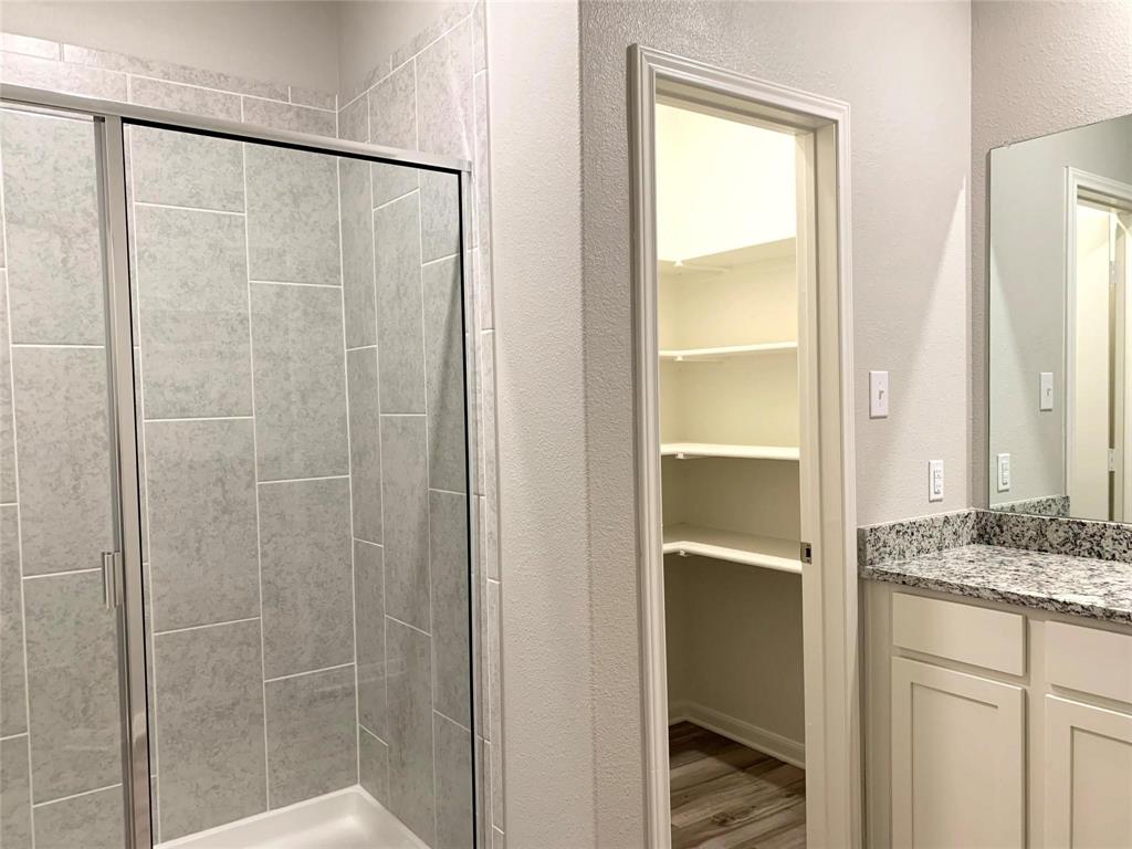 144 Emma Drive Anna, TX 75409 - Photo 29 of 34 a bathroom with a granite countertop shower and a sink