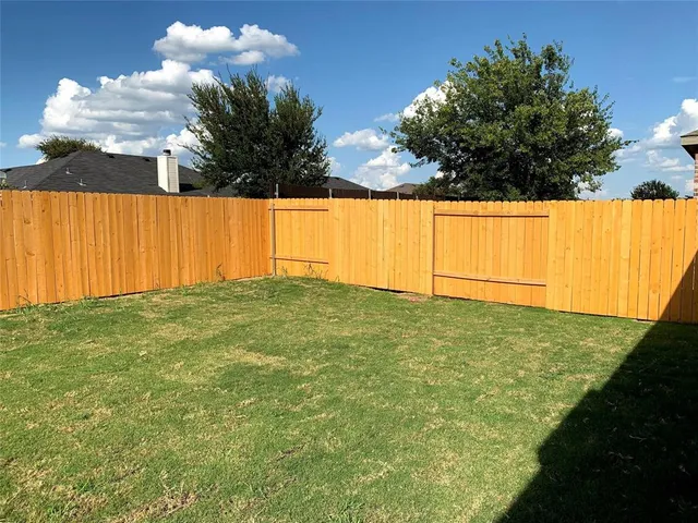 a backyard of a house with lots of green space