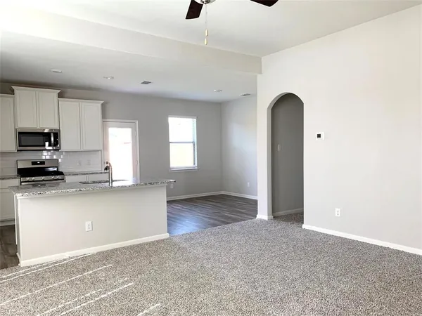 a kitchen with stainless steel appliances granite countertop a stove a sink and a refrigerator