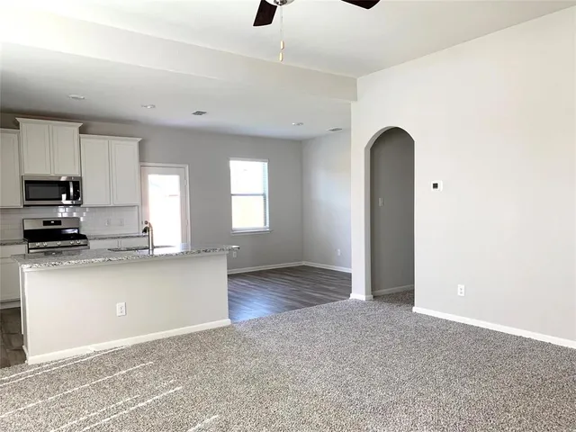 a kitchen with stainless steel appliances granite countertop a stove a sink and a refrigerator