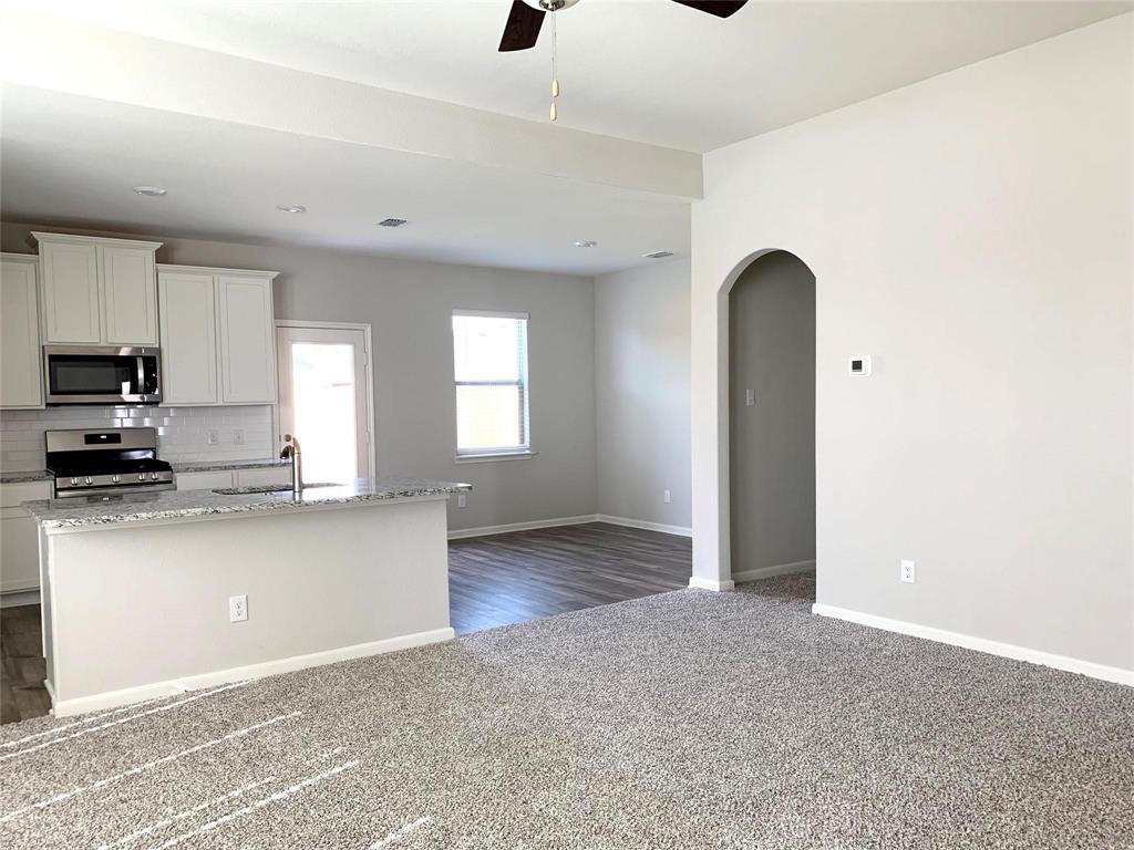144 Emma Drive Anna, TX 75409 - Photo 4 of 34 a kitchen with stainless steel appliances granite countertop a refrigerator and a sink