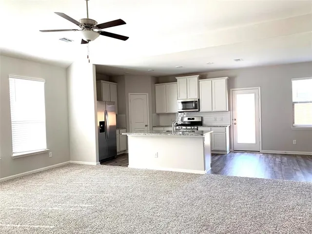 a view of a kitchen cabinets a sink and wooden floor
