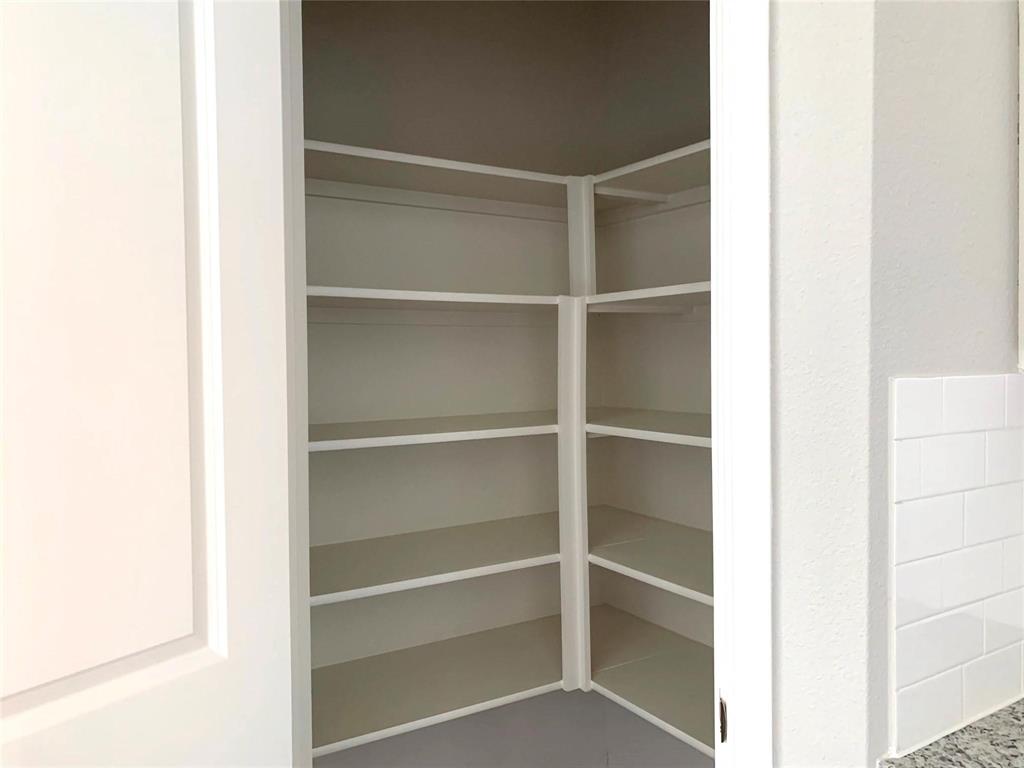 144 Emma Drive Anna, TX 75409 - Photo 9 of 34 a view of walk in closet with empty racks